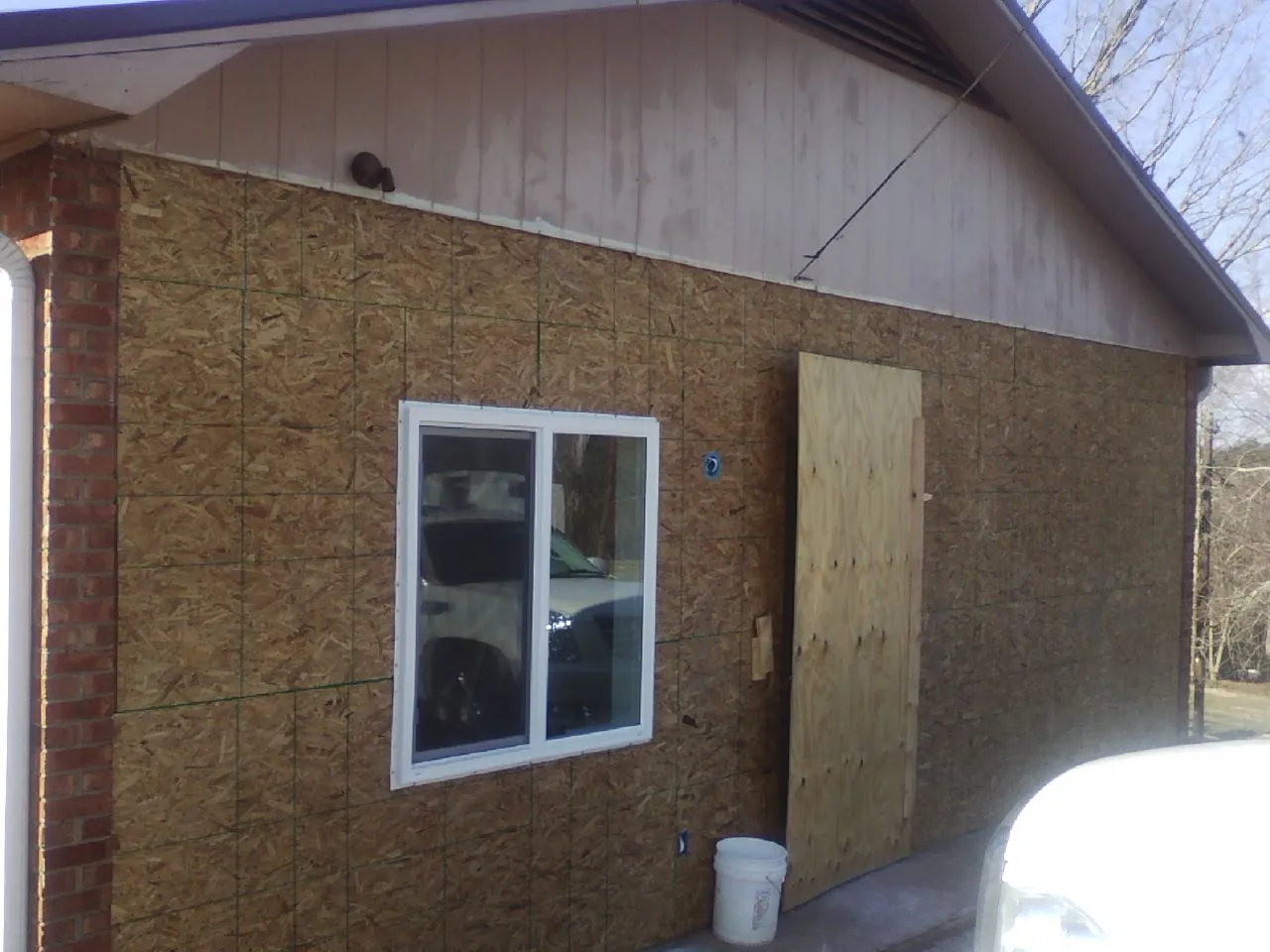 OSB sheathing on a garage addition wall before siding in Venango