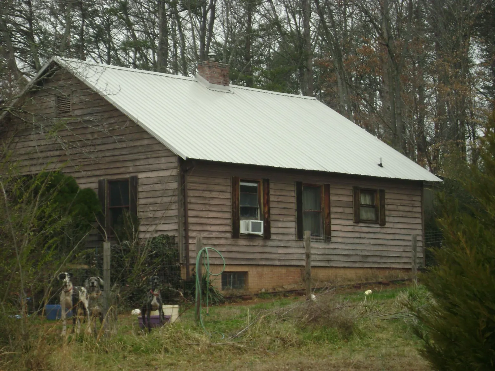 White metal roof on an old wood sided farmhouse, from a Metal Roof Installation job in Venango
